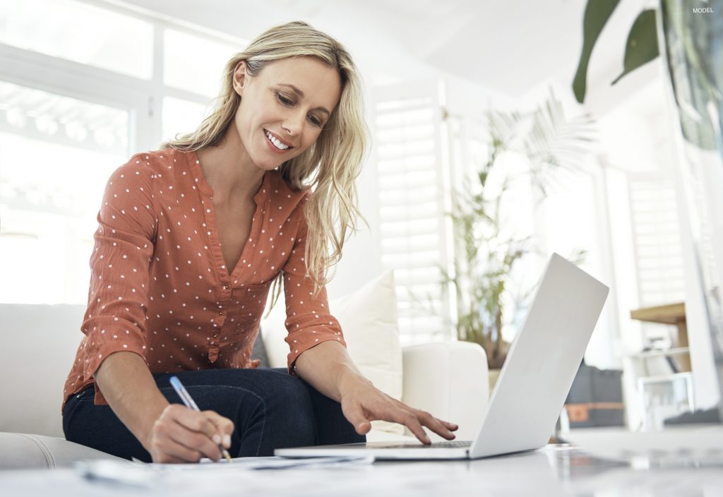 Woman smiling while using computer