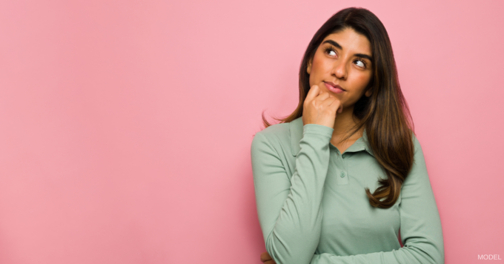 Woman contemplating with hand on chin